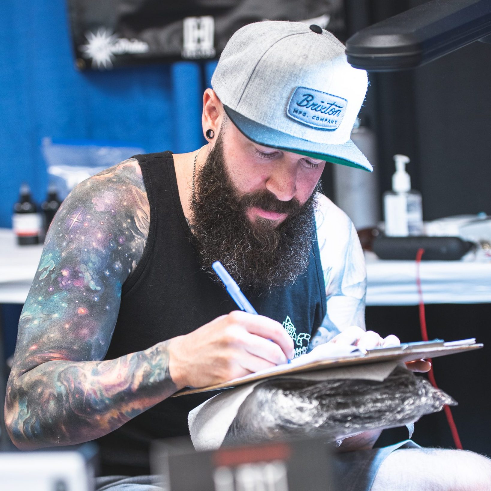 Photo of a tattoo artist signing a paper