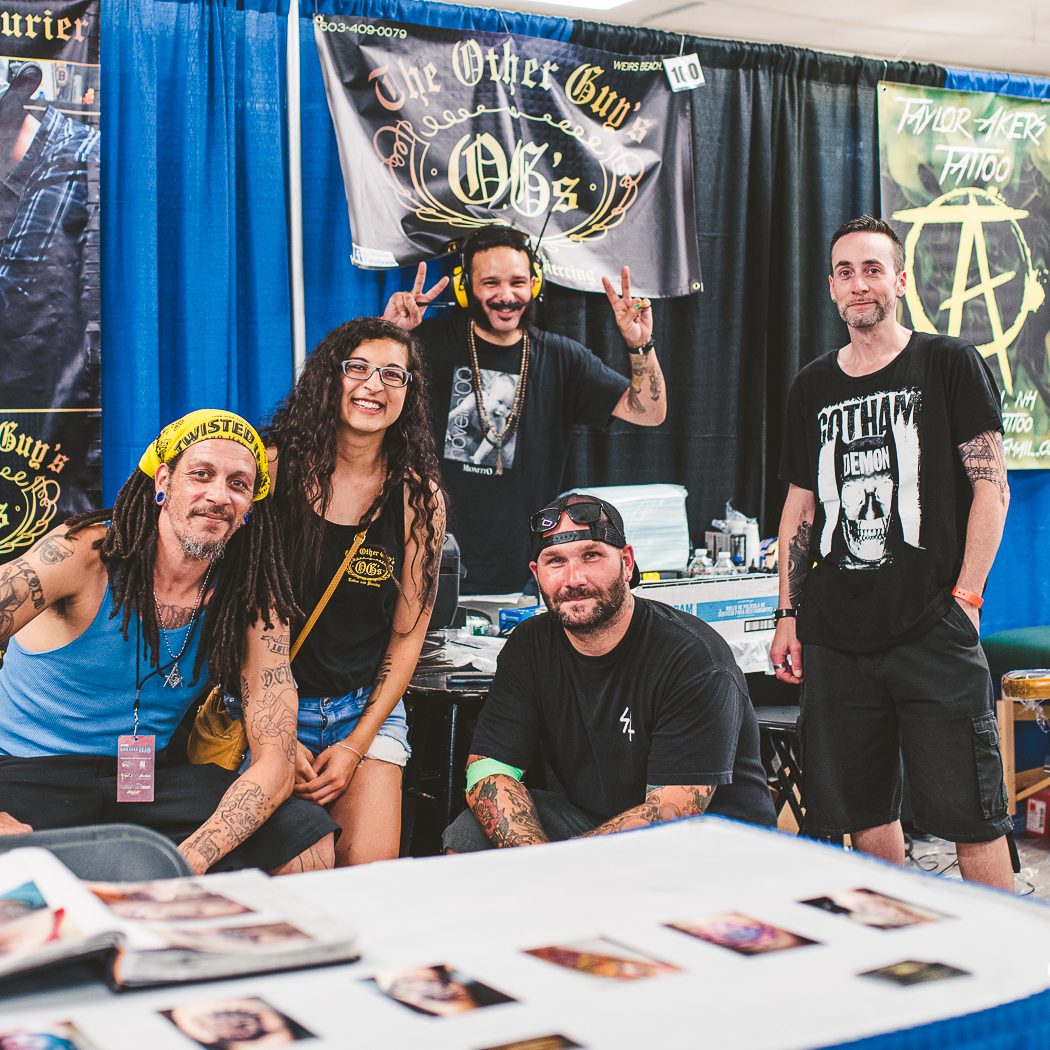 Photo of a group of people at a tattoo expo booth